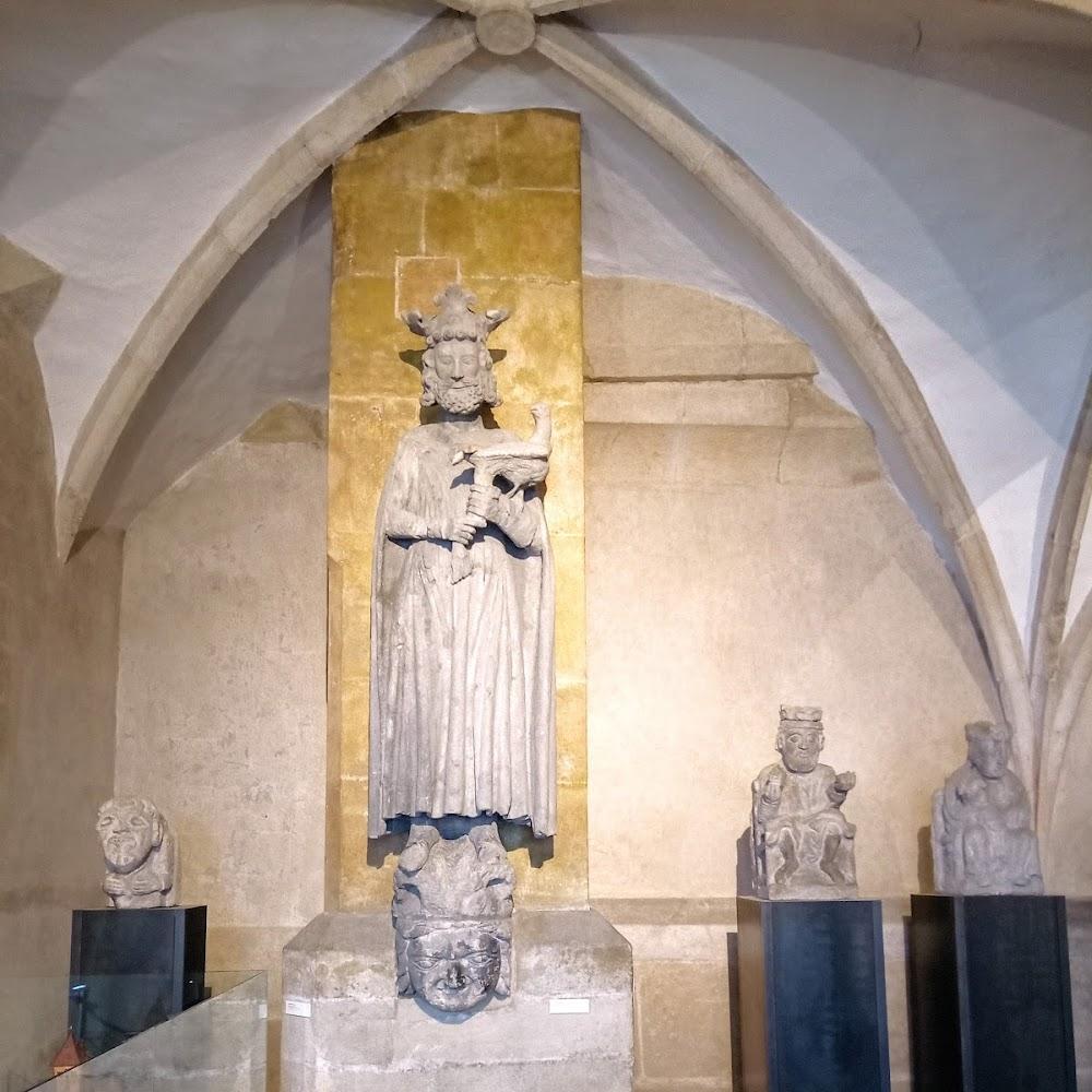 Stone statues in a vaulted hall.  St. Vitus Cathedral.